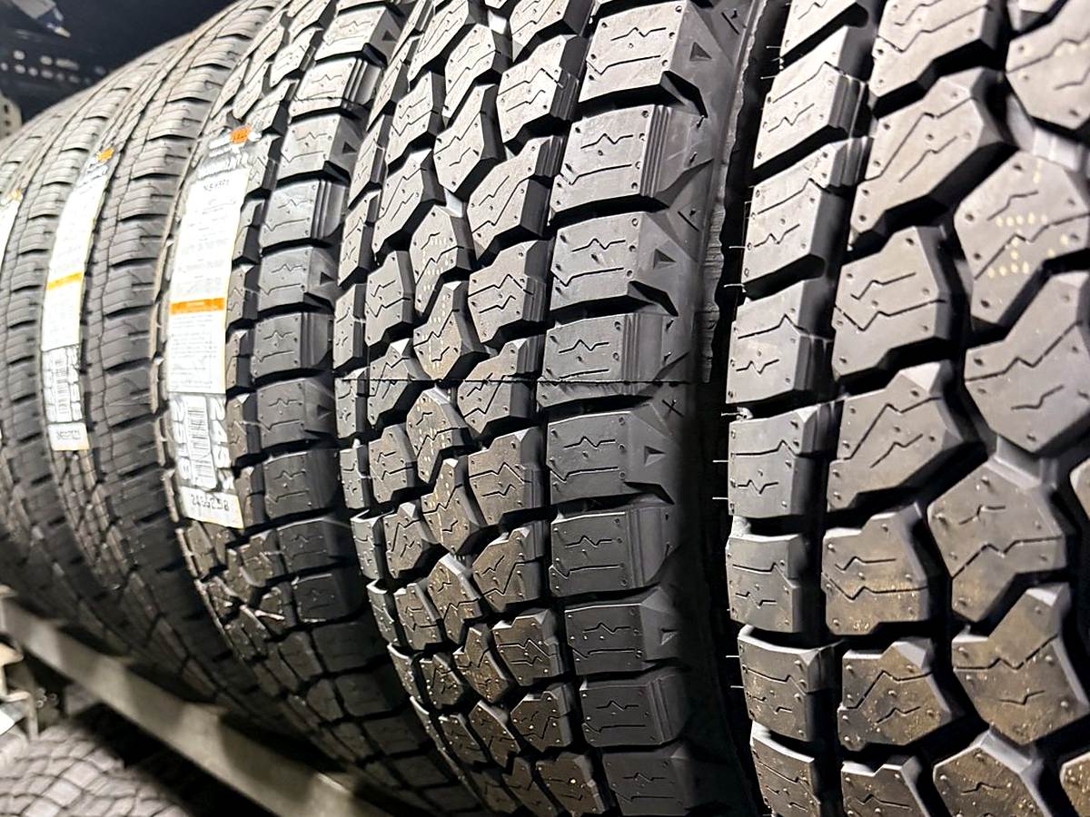 New all-terrain truck and SUV tires on the tire rack at Llantera Del Norte INC, 606 Peoria St, Aurora, Colorado / Llantas nuevas todo terreno para camioneta y SUV en el rack de Llantera Del Norte INC en Aurora, Colorado